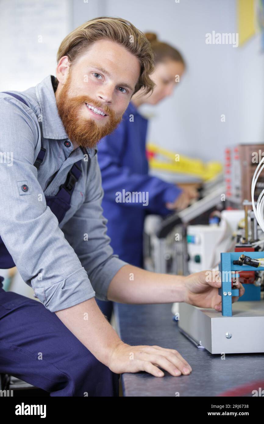 industrial worker assembles electronic components in a factory Stock Photo