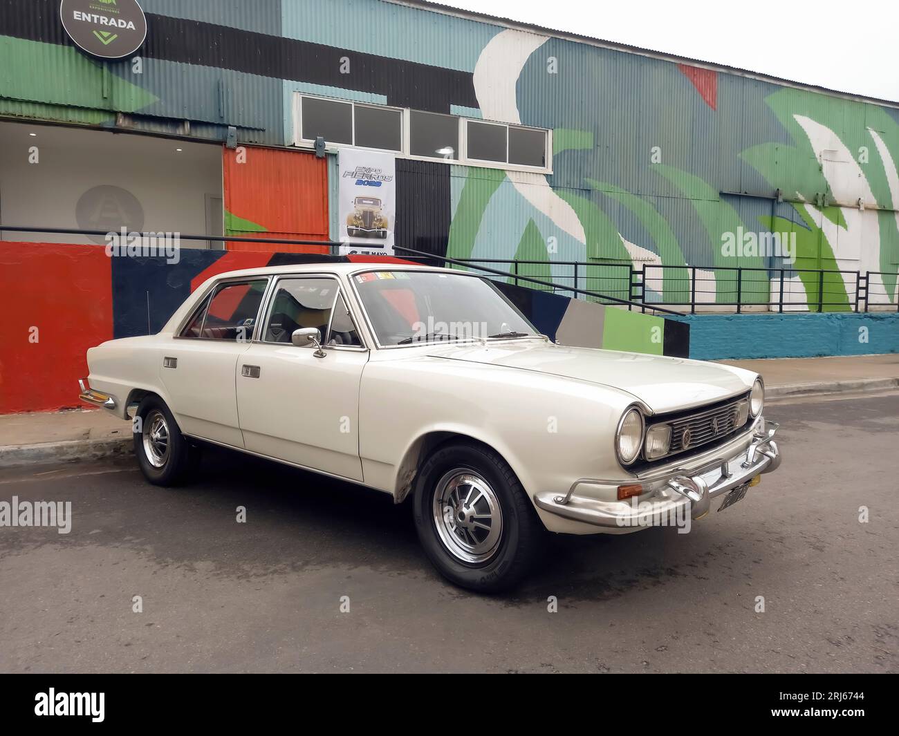 An old white 1970s IKA Renault Torino sedan in the street Stock