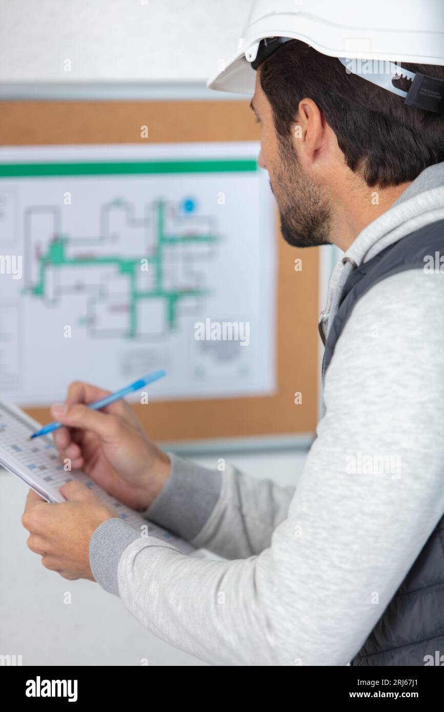 architect checking insulation during house construction Stock Photo