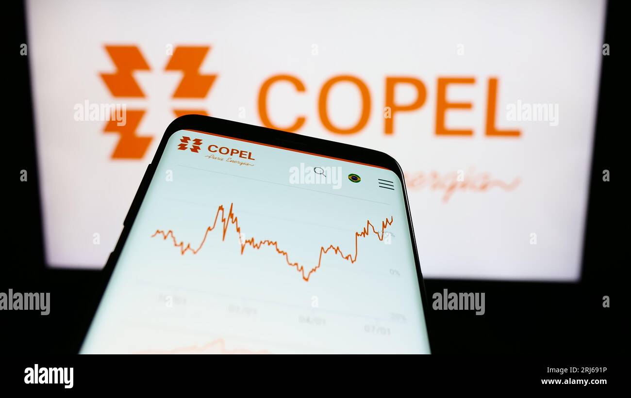 Mobile phone with website of company Companhia Paranaense de Energia (Copel) on screen in front of logo. Focus on top-left of phone display. Stock Photo