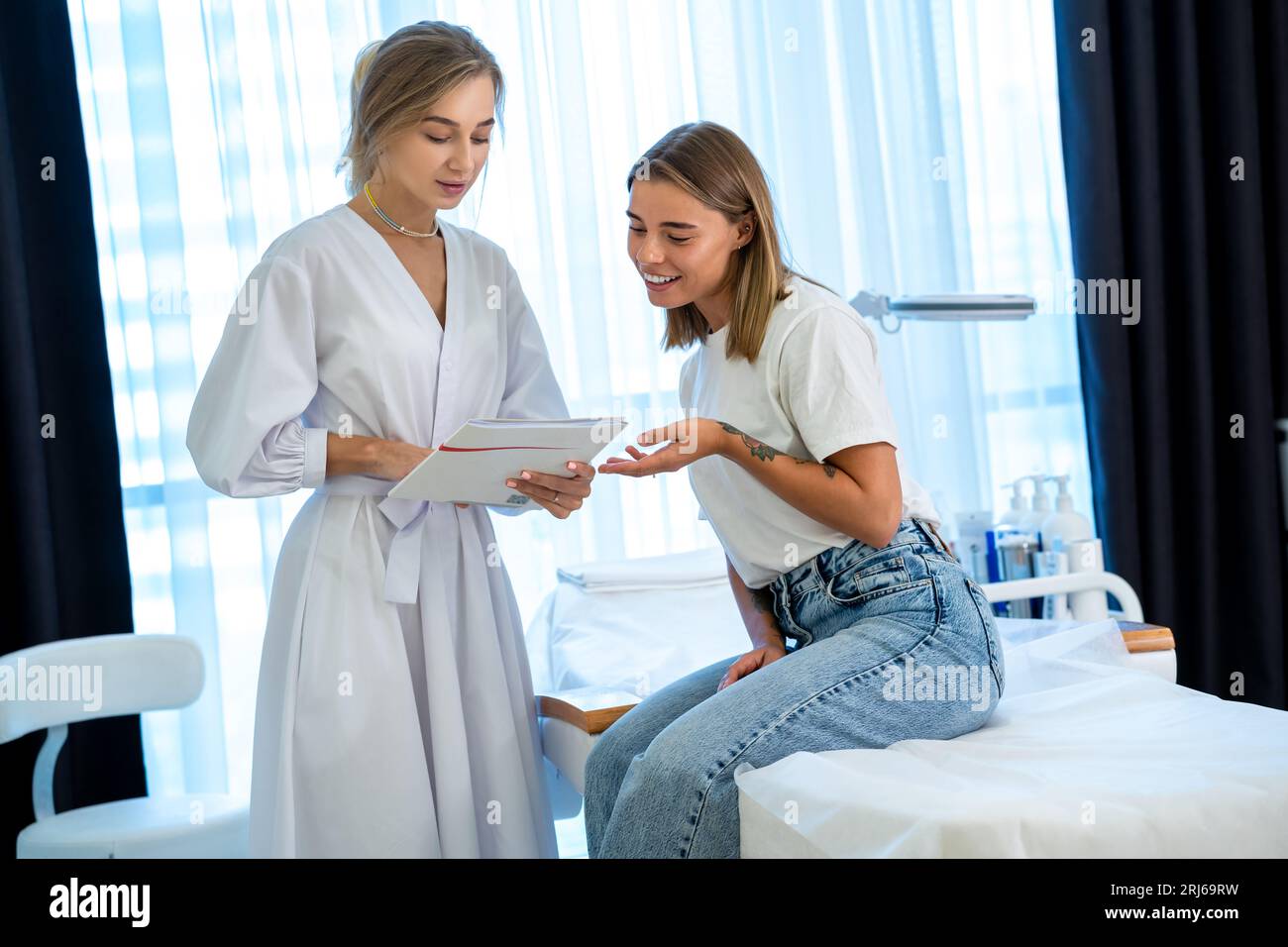 Cosmetician woman with papers talking to woman before procedure sign