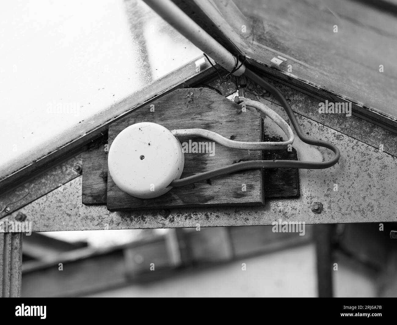 A grayscale shot of a homemade electric connection in a greenhouse. Stock Photo