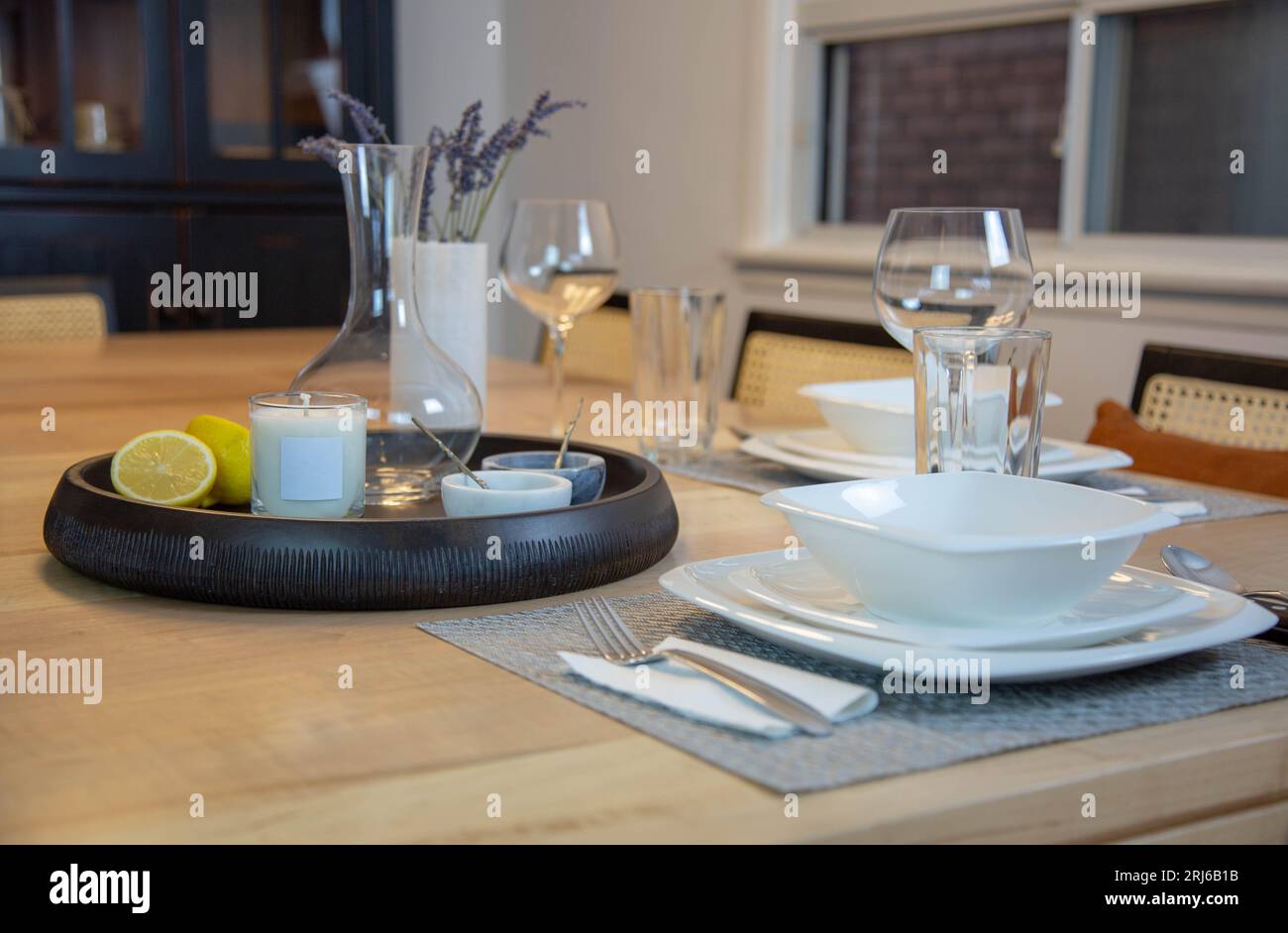 A dining table is set with dinnerware for a meal Stock Photo
