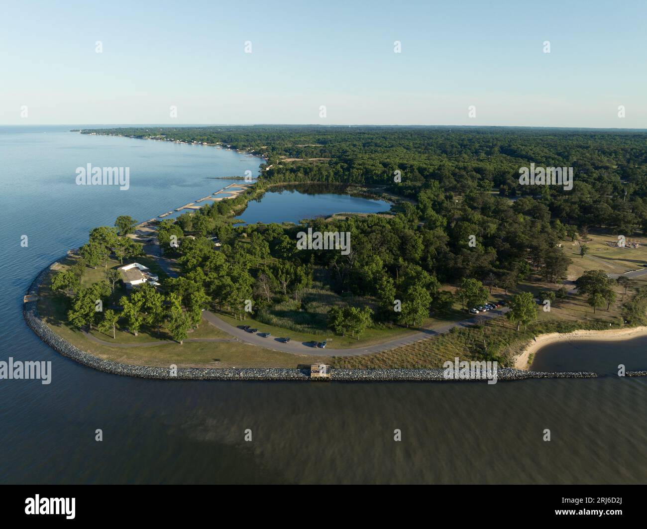 An aerial view of green landscape surrounded by a lake Stock Photo - Alamy