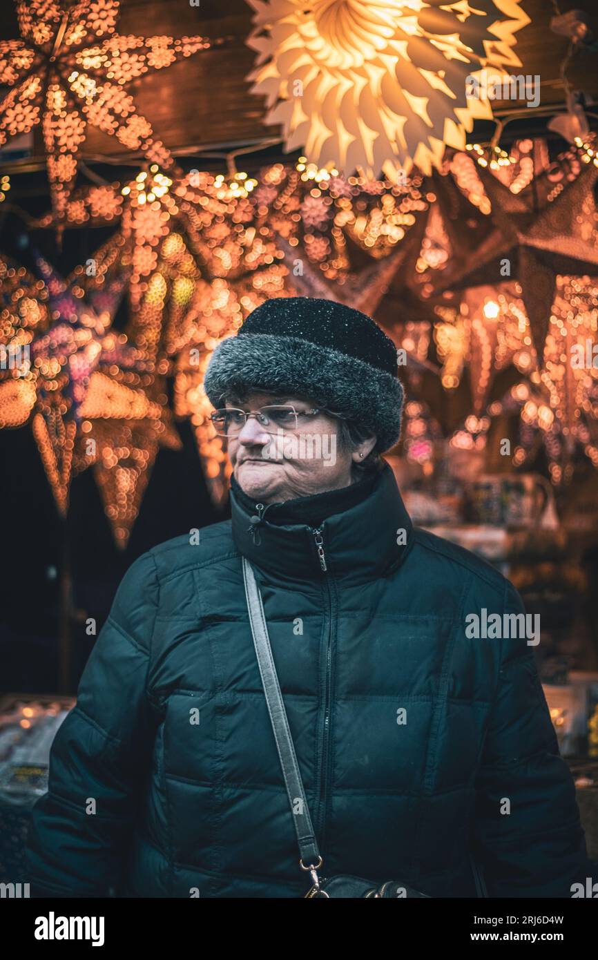 A person visiting a Christmas market in Basel, Switzerland on a snowy day. Stock Photo