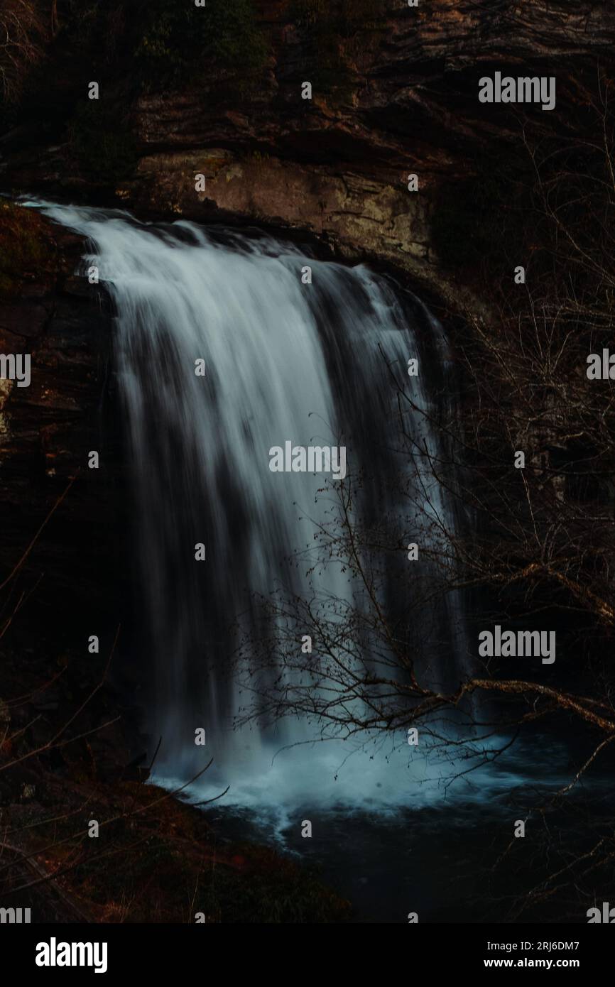 A powerful and majestic waterfall cascades down the side of a rocky ...