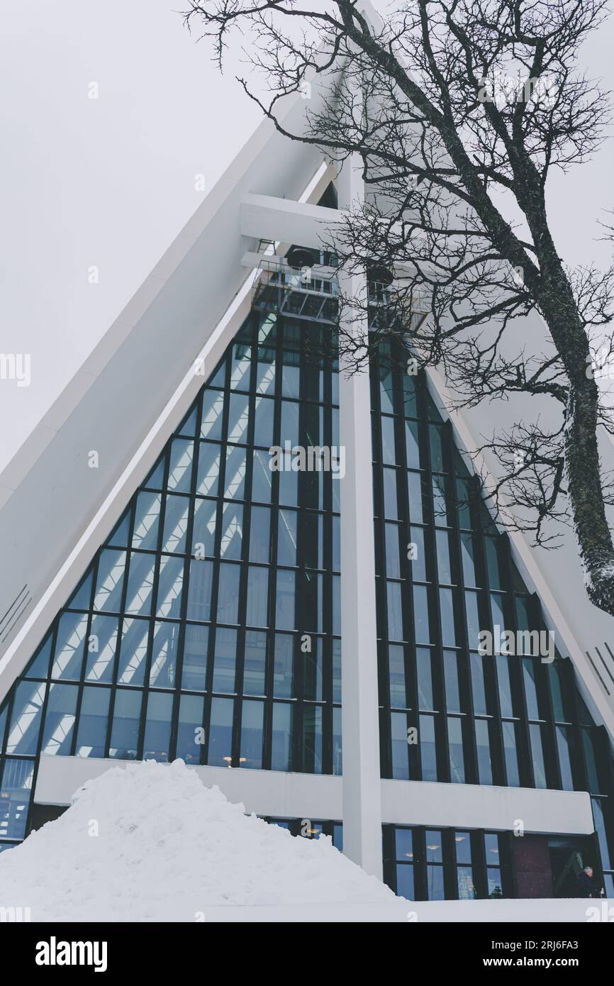 A modern white abstract building stands in stark contrast to the snow