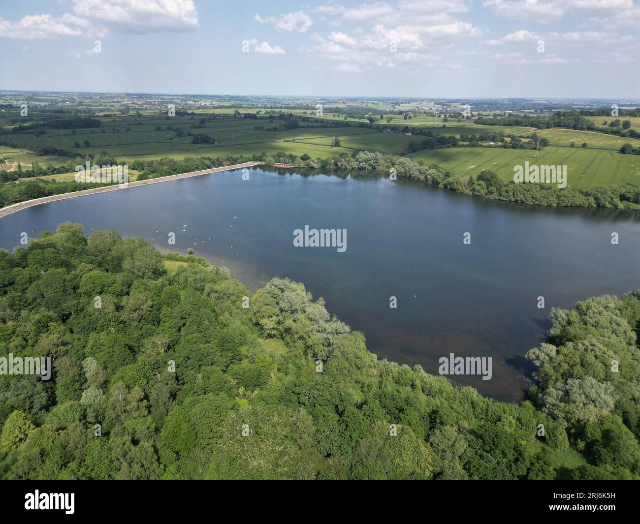 An aerial view of a lush landscape surrounding a tranquil lake, with ...