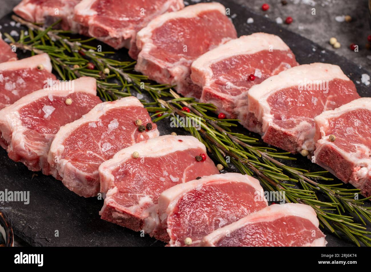 Fresh lamb back fillet. Raw lamb fillet on dark background. Butcher