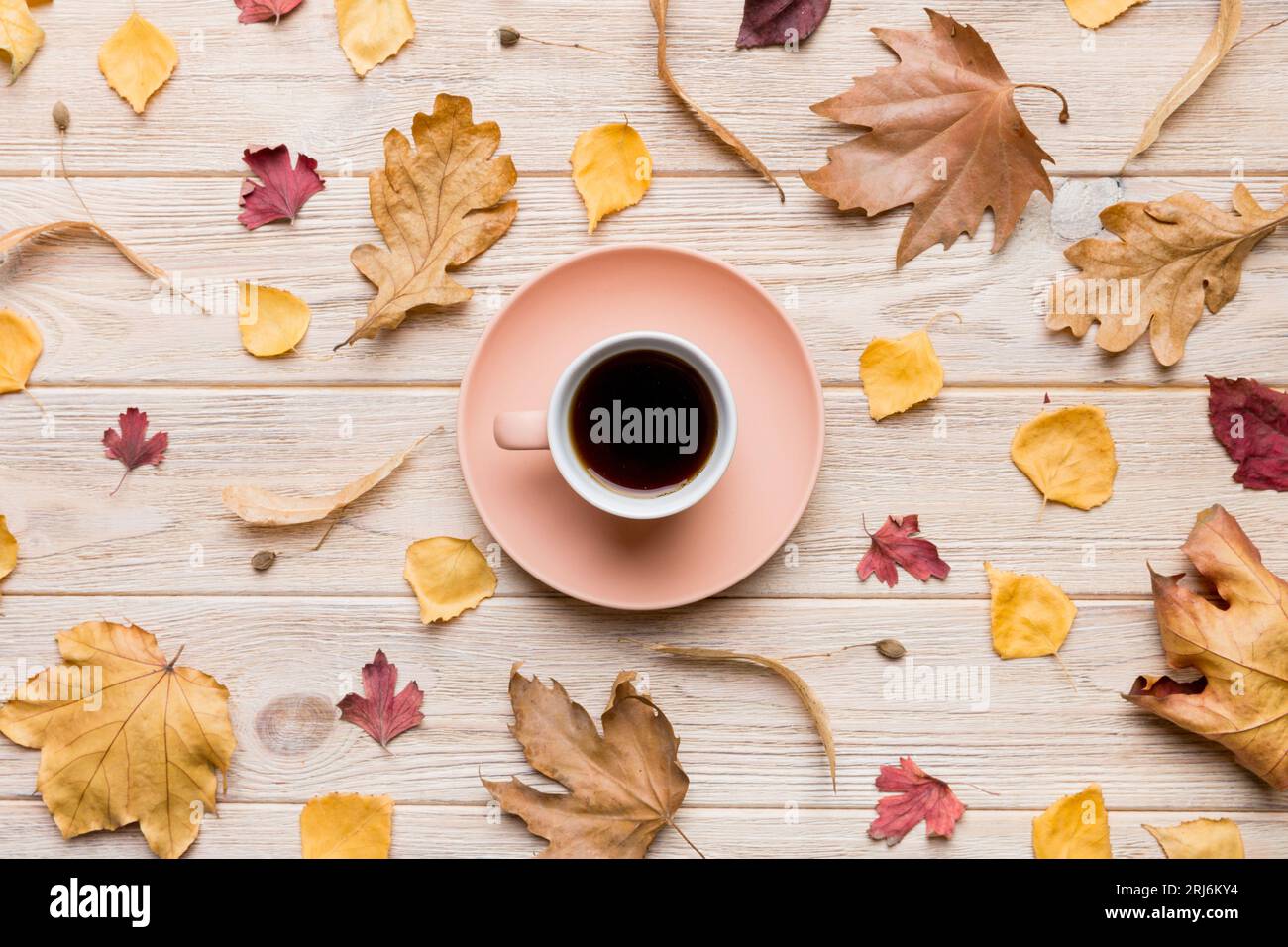 Flat lay composition with colorful Autumn cup of coffee and leaves on a ...