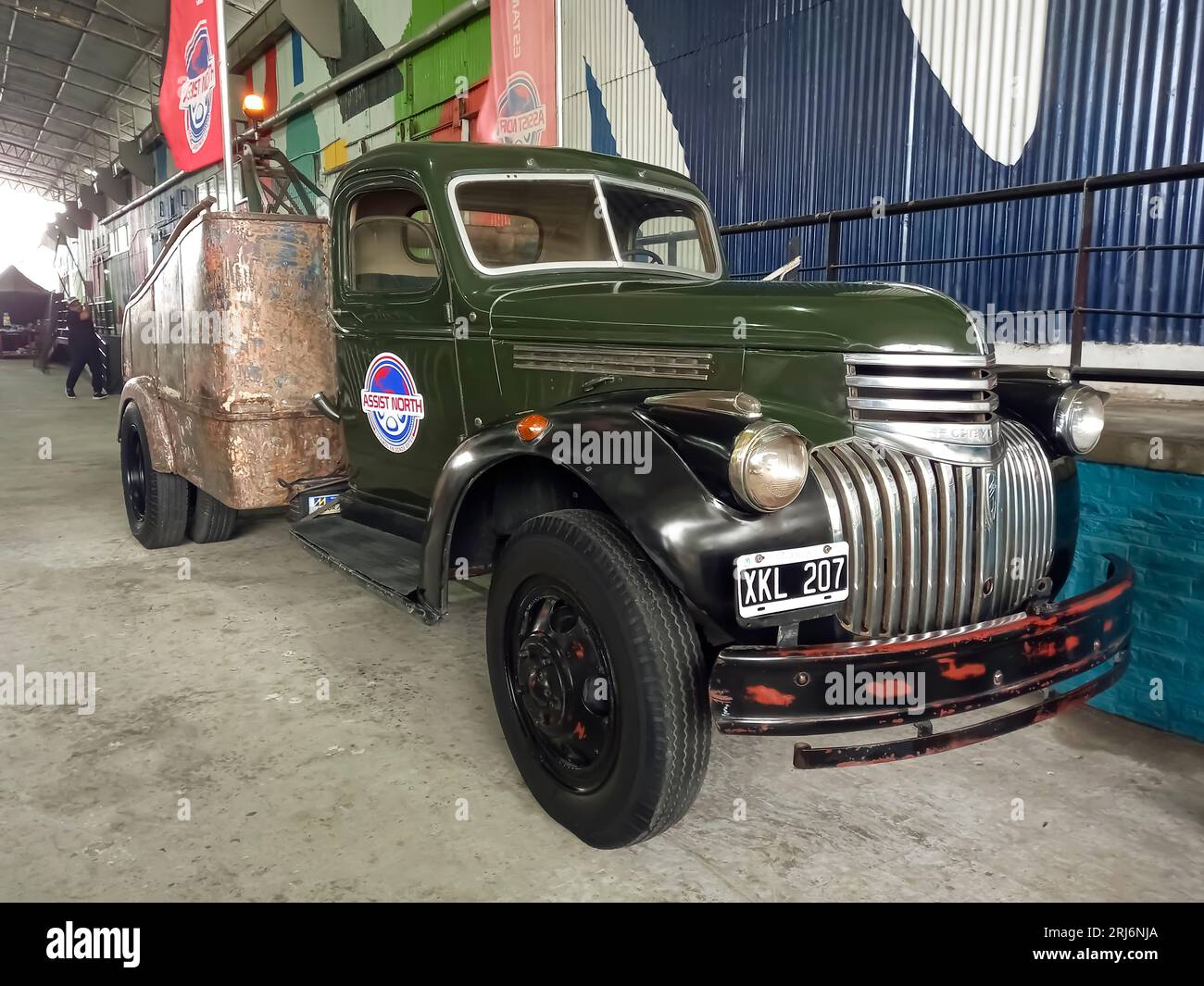old black and green 1940s Chevrolet AK series roadside assistance tow
