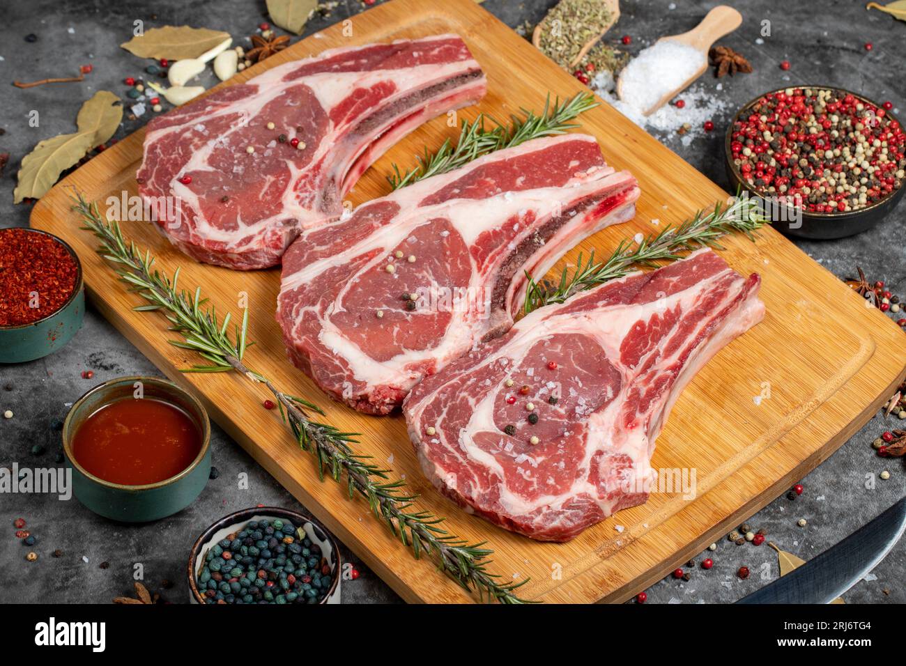 Veal rib boned raw chops. Raw veal cutlet on dark background. Butcher