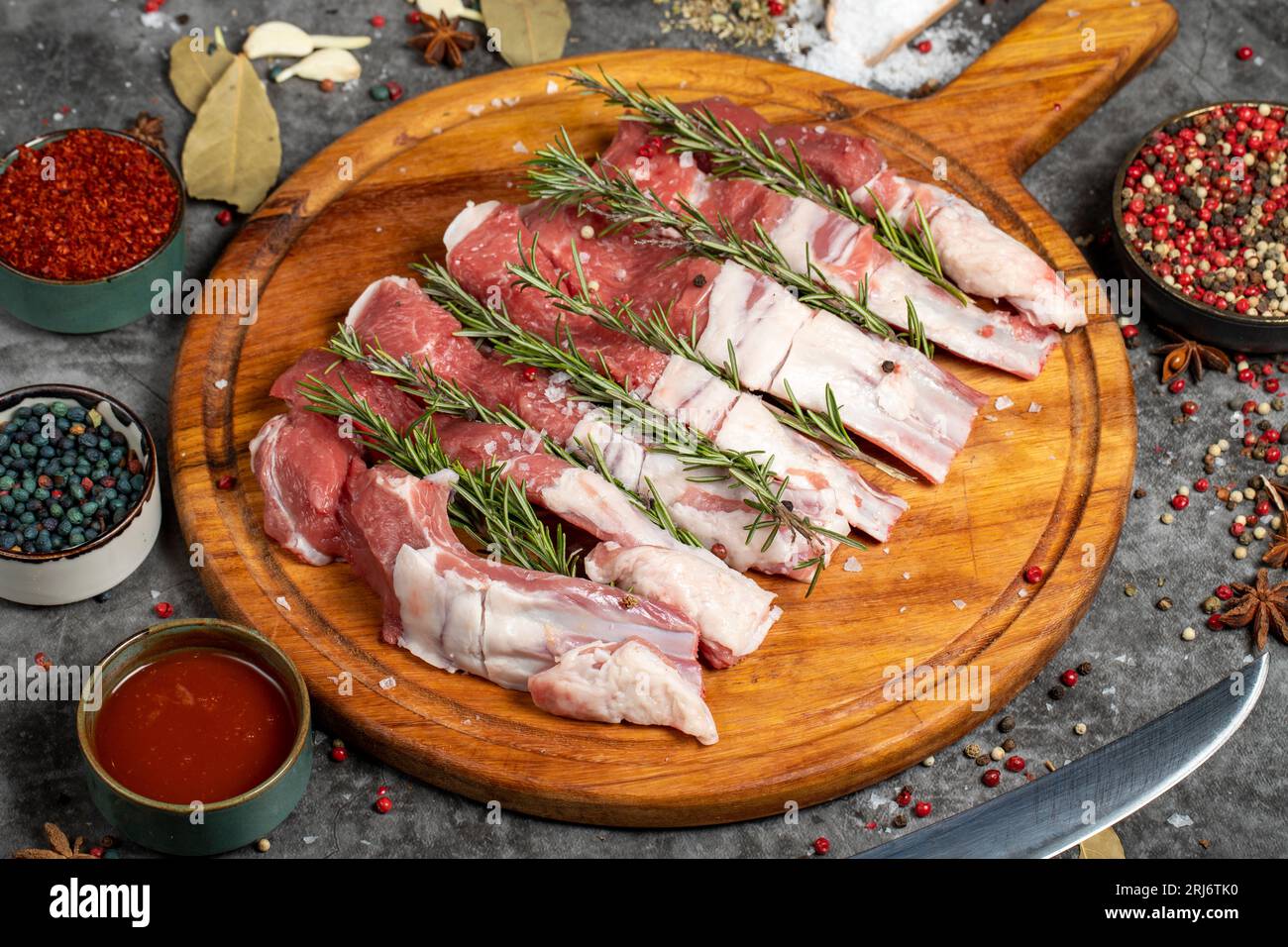 Fresh beef ribs. Pieces of raw beef ribs on a dark background. Butcher
