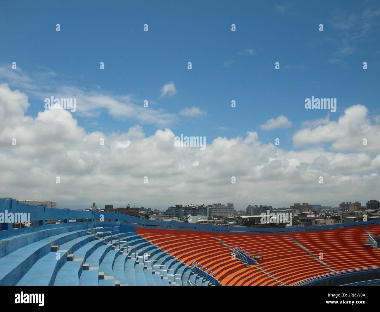 An aerial view of an indoor baseball stadium featuring a blue sky background Stock Photo