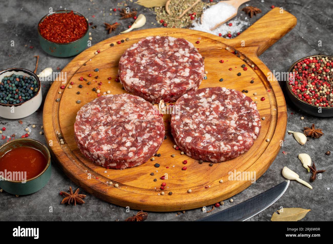 Beef hamburger patty. Fresh raw beef burger patties on dark background
