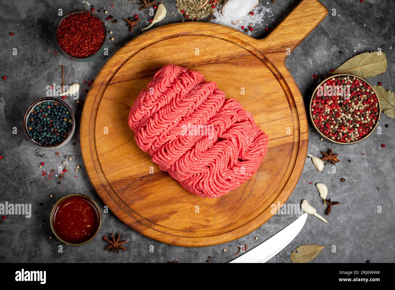 Ground beef. Fresh raw beef minced meat on dark background. Butcher products. Top view Stock Photo