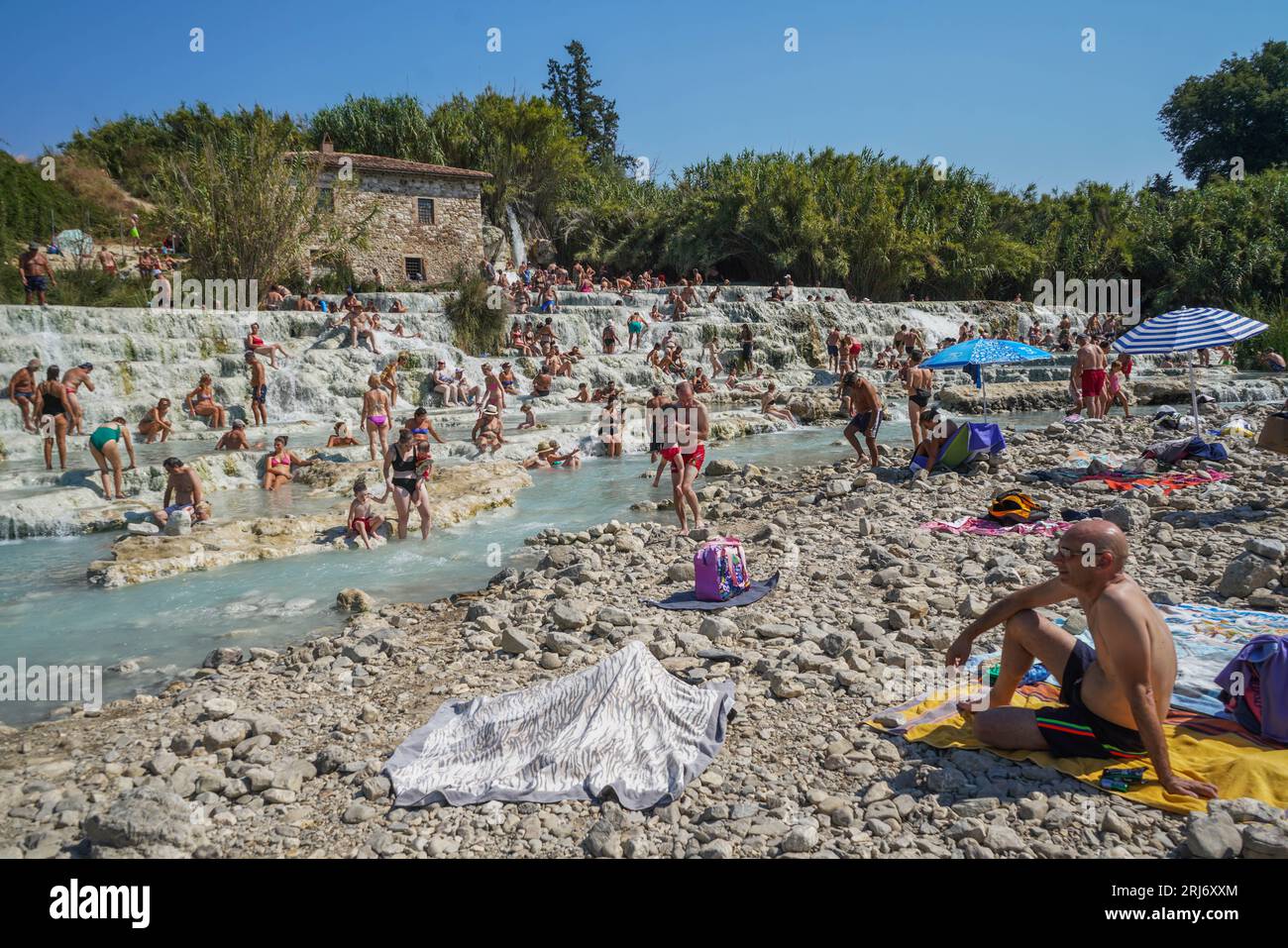 Saturnia, Tuscany Italy. 21 August 2023 . People enjoy the sulphurous ...