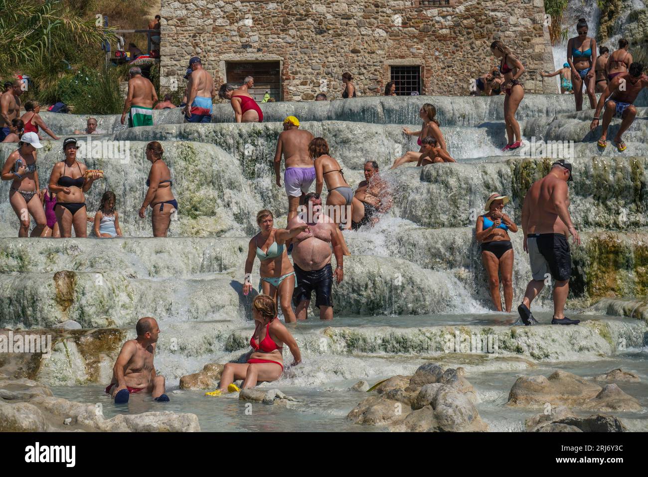 Saturnia, Tuscany Italy. 21 August 2023 . People enjoy the sulphurous ...
