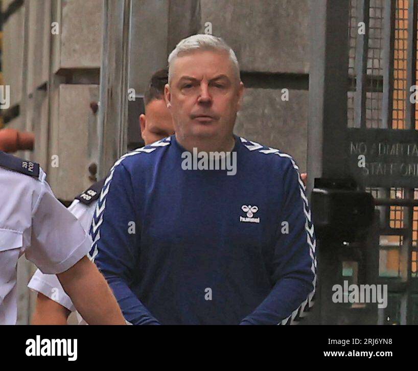 RETRANSMITTED AMENDING LOCATION Christopher Paul O'Kane is led to a prison van after appearing at Ballymena Court, where he was charged with possessing documents or records likely to be useful to terrorists and possession of two mobile phones for use in terrorism. Picture date: Monday August 21, 2023. Stock Photo