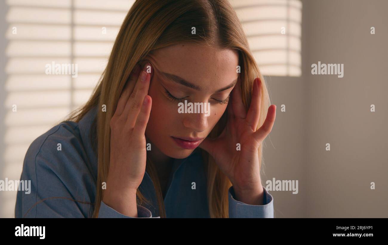 Stressed Caucasian businesswoman nervous doing paperwork writing idea business mistake rips sheet of paper from notebook throw away anxious woman Stock Photo