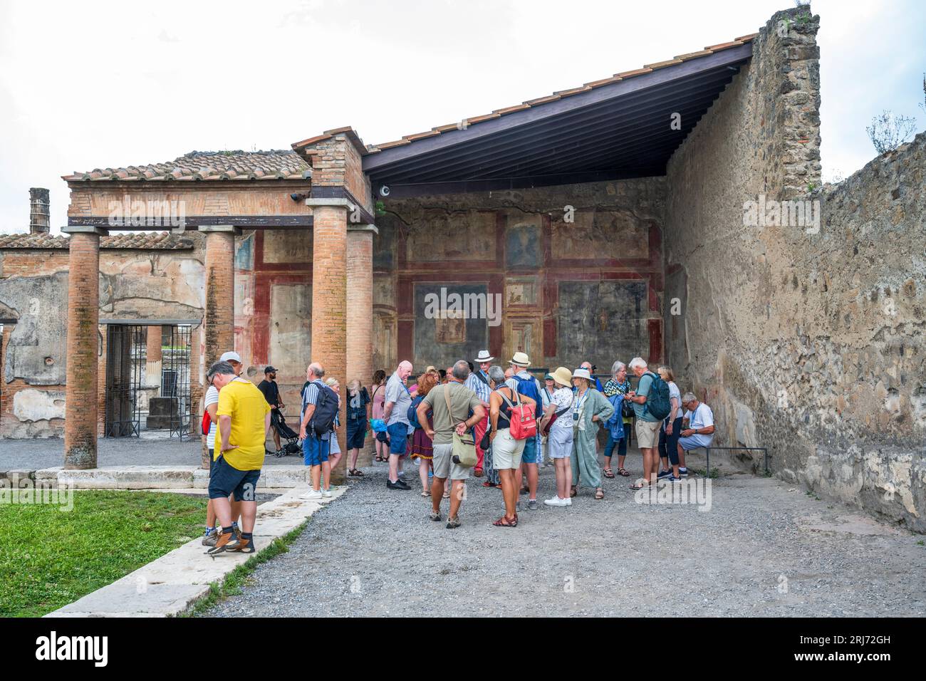 Tourists in the Macellum (meat and fish market) next to the Forum in the ruins of the ancient city of Pompeii in the Campania Region of Southern Italy Stock Photo