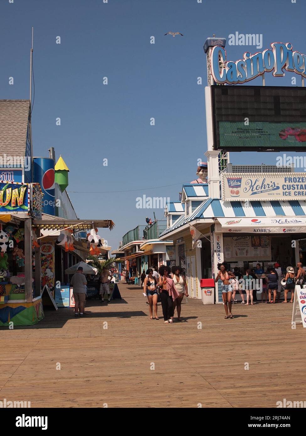 Seaside Heights, New Jersey boardwalk crowded with vacationers on a beautiful summer day. Stock Photo