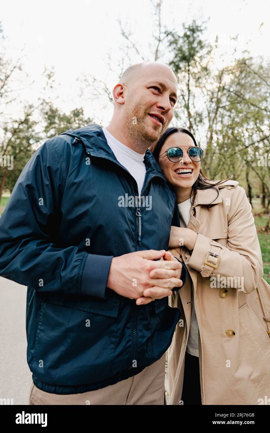 Happy romantic couple enjoying a walk in the park Stock Photo - Alamy