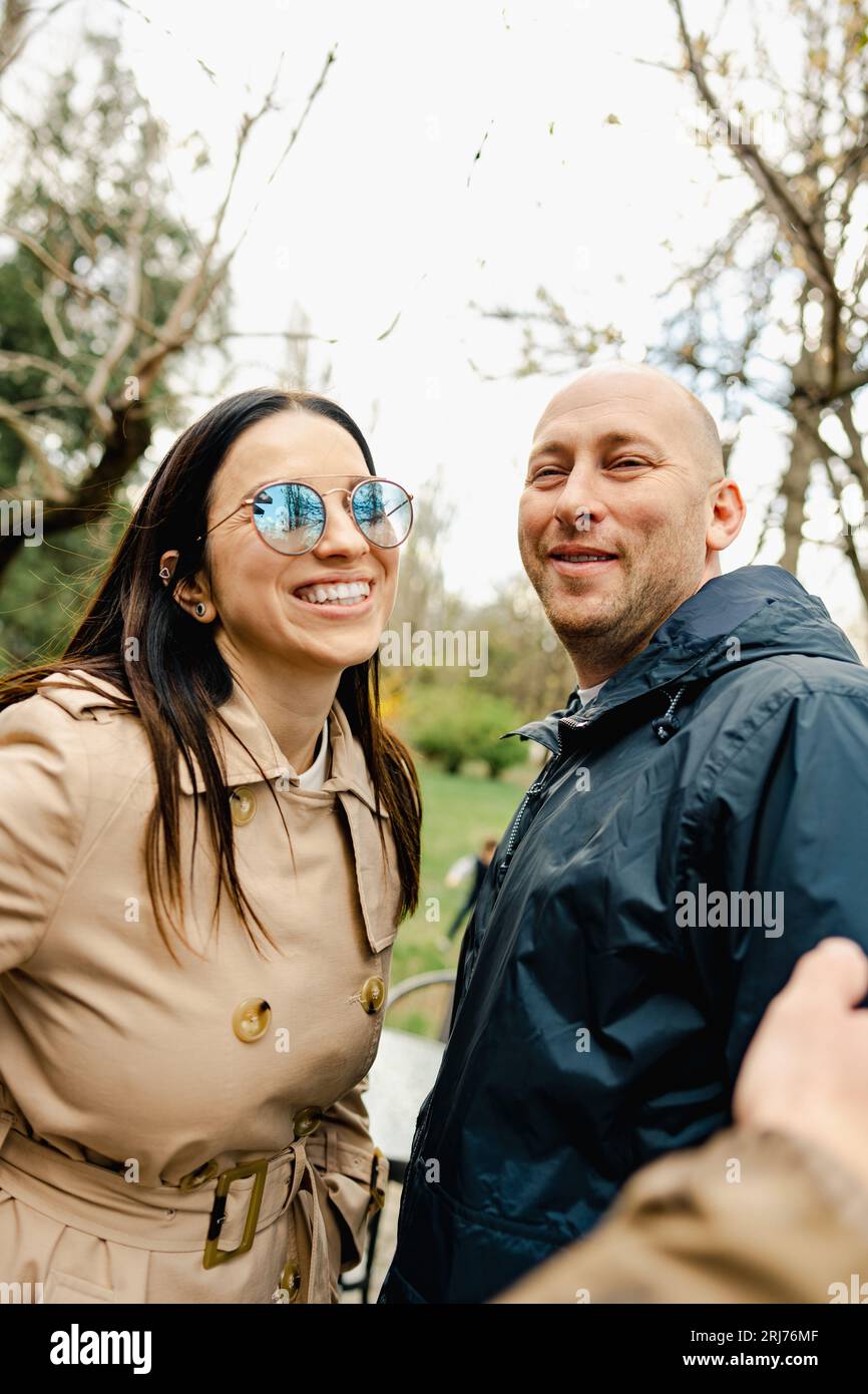 Happy romantic couple enjoying a walk in the park Stock Photo - Alamy