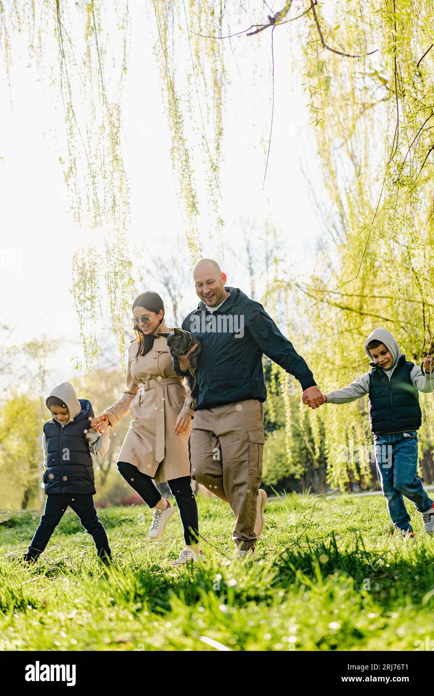 Happy family on a walk in the park Stock Photo - Alamy