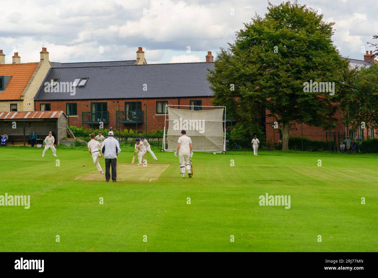 Batsman blocks the ball during a Duncombe Park Cricket Club Sunday League match at Helmsley Sports & Recreation Ground in West Yorkshire, UK. Stock Photo