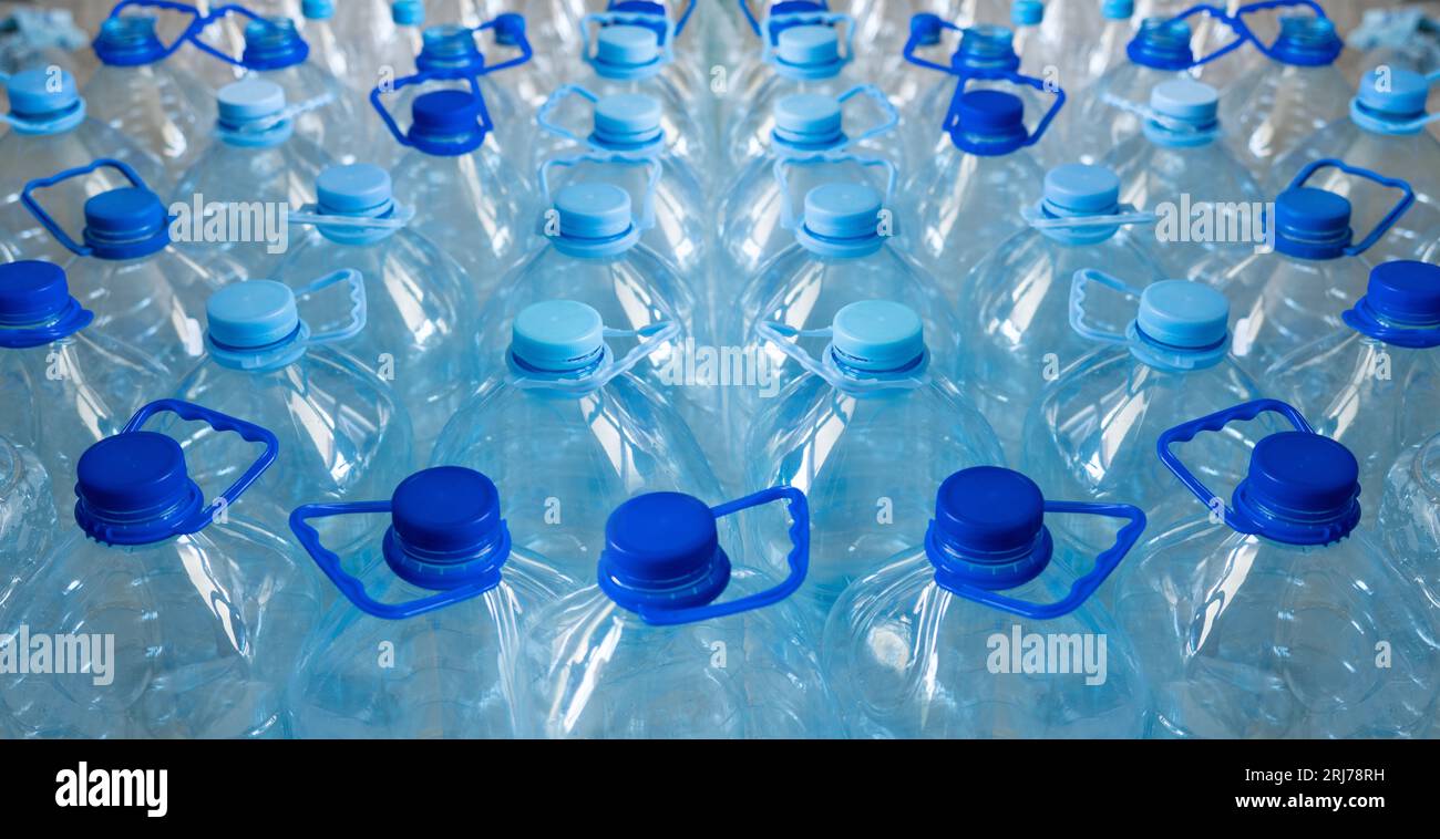 Empty plastic bottles in a rows. Plastic pollution. Stock Photo