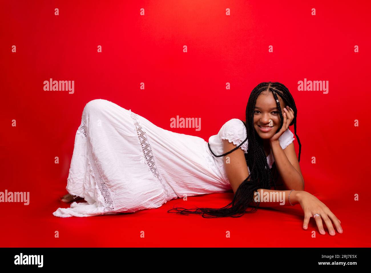 Black girl sitting on red hi-res stock photography and images - Alamy