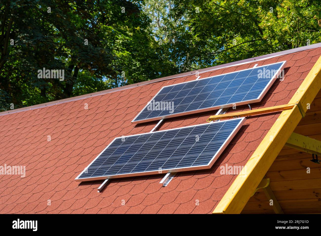 Solar panel on the roof of the house. Red tiles. Photovoltaic panels ...