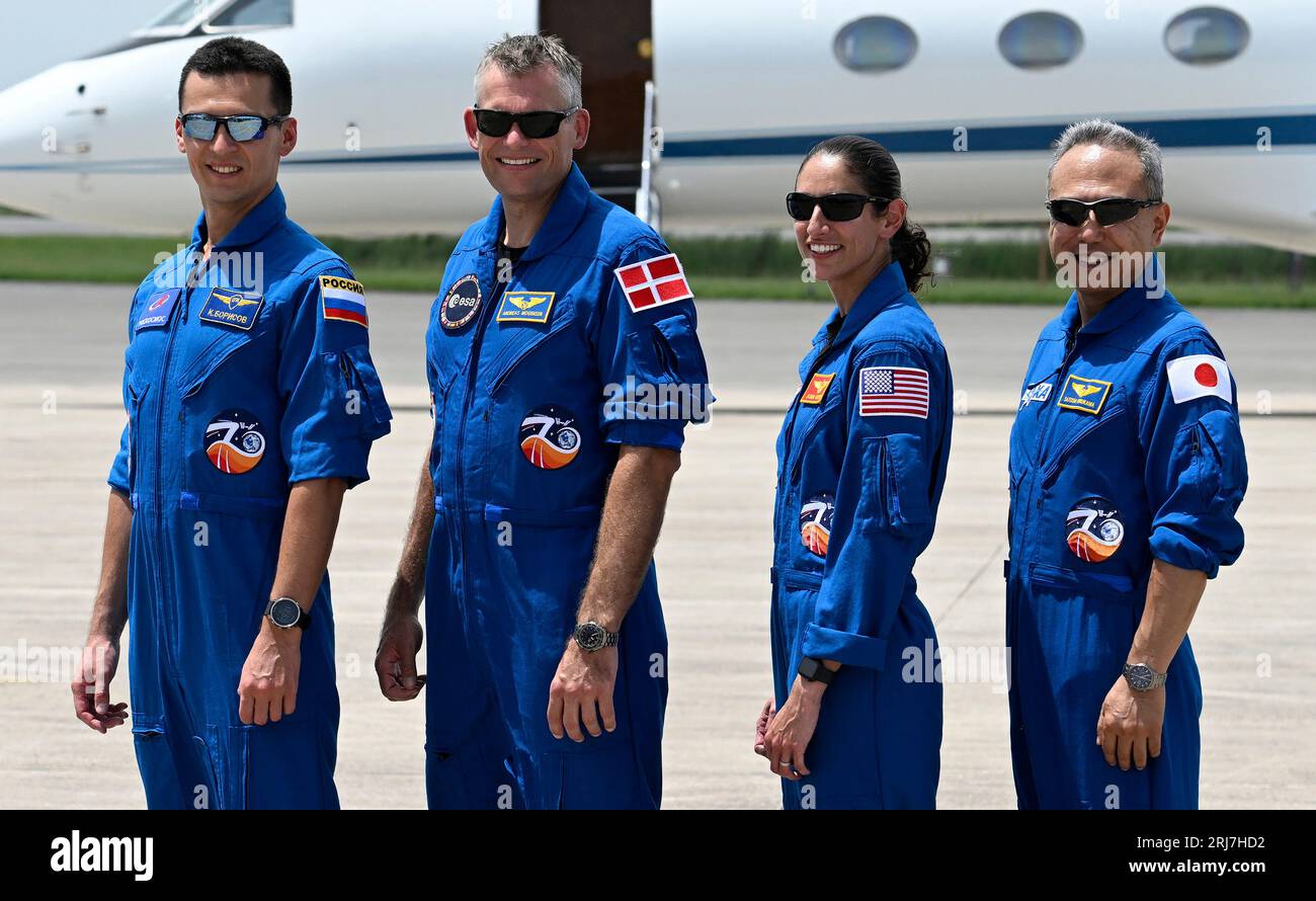 Members of the next NASA-SpaceX crew, Roscosmos cosmonaut Konstantin Borisov,  ESA astronaut Andreas Morgensen, NASA astronaut Jasmin Moghbeli and JAXA  astronaut Satoshi Furukawa (i to r) pose to display their Nations' flags