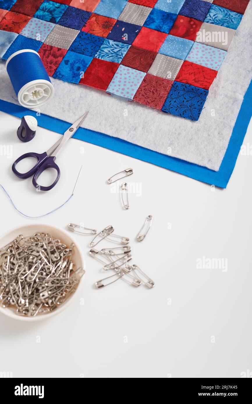 Assembling of a quilt sandwich, curved basting pins and sewing