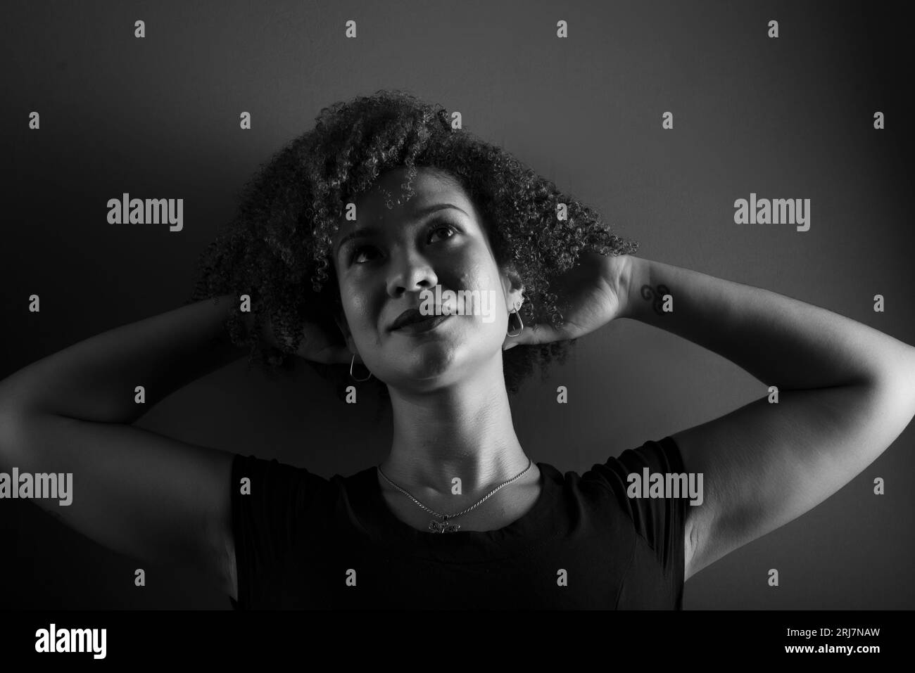 Black and white portrait of a beautiful, attractive woman posing for a photo. happy and confident person Stock Photo