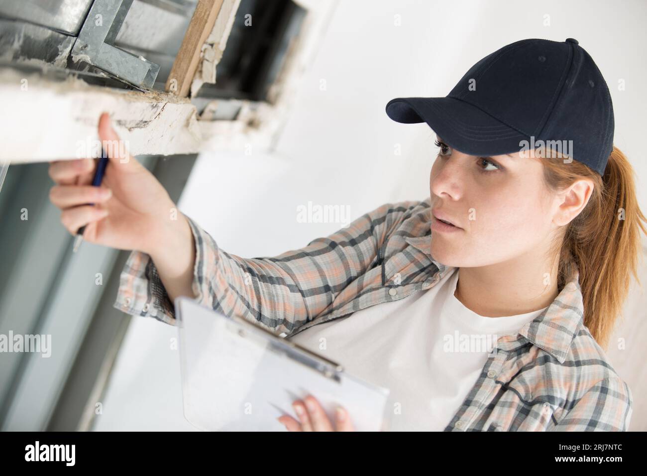 architect woman checking windows on site Stock Photo