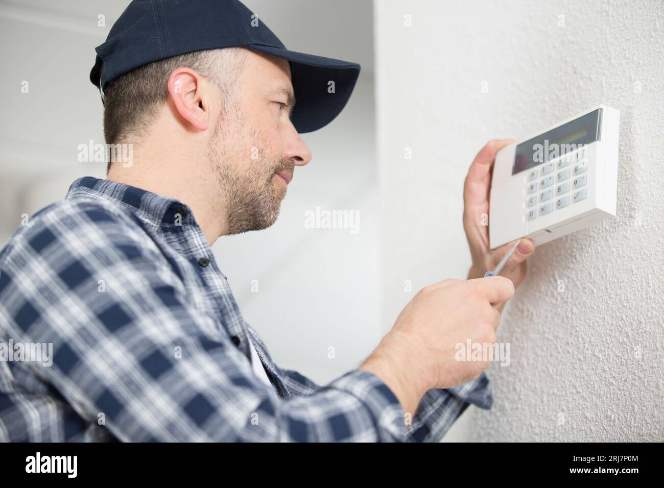installing a programmable room thermostat Stock Photo Alamy