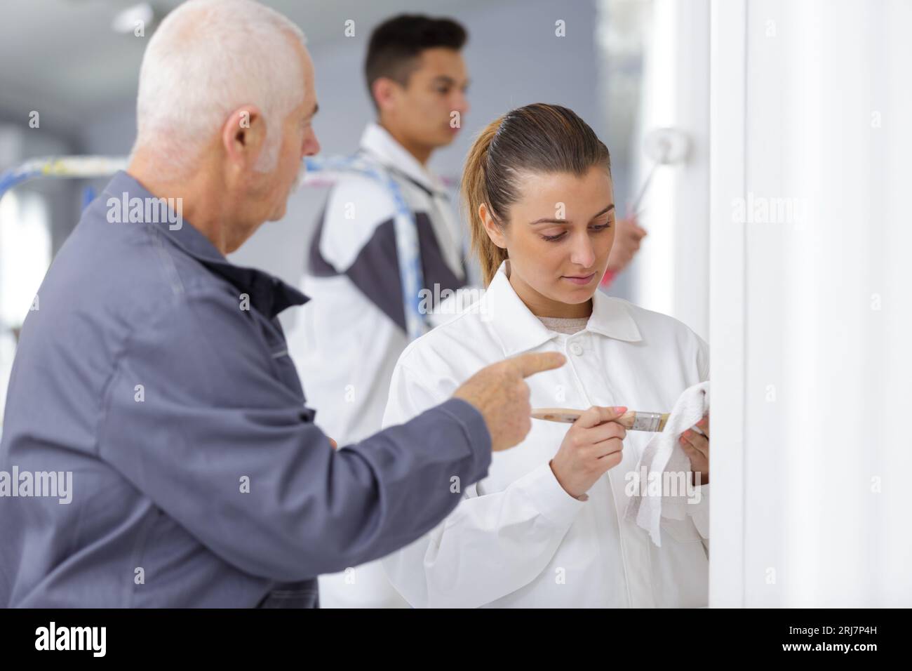 female apprentice decorator in training Stock Photo