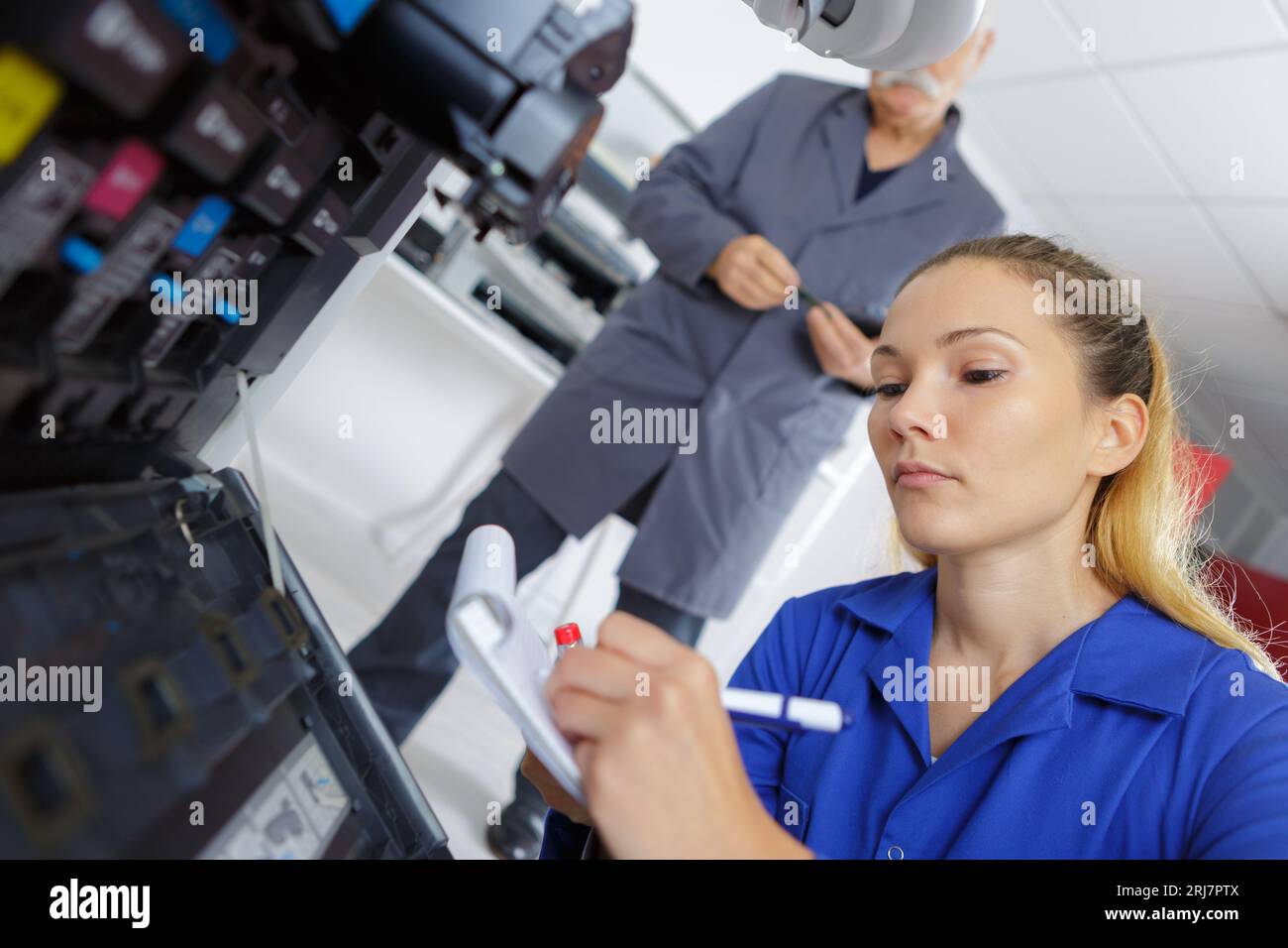 female technician fixing a printer Stock Photo