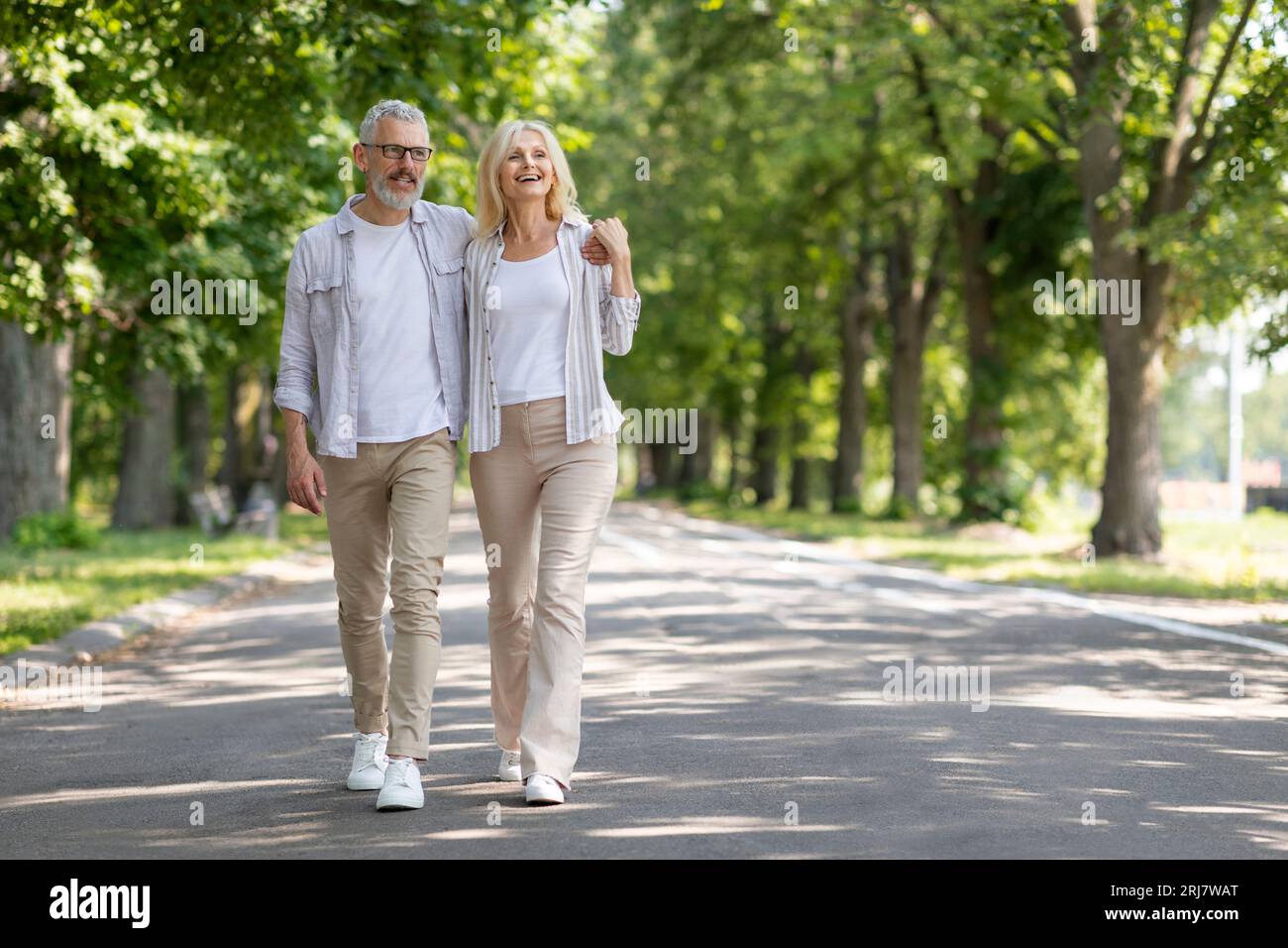Senior woman walking in park hi-res stock photography and images - Alamy