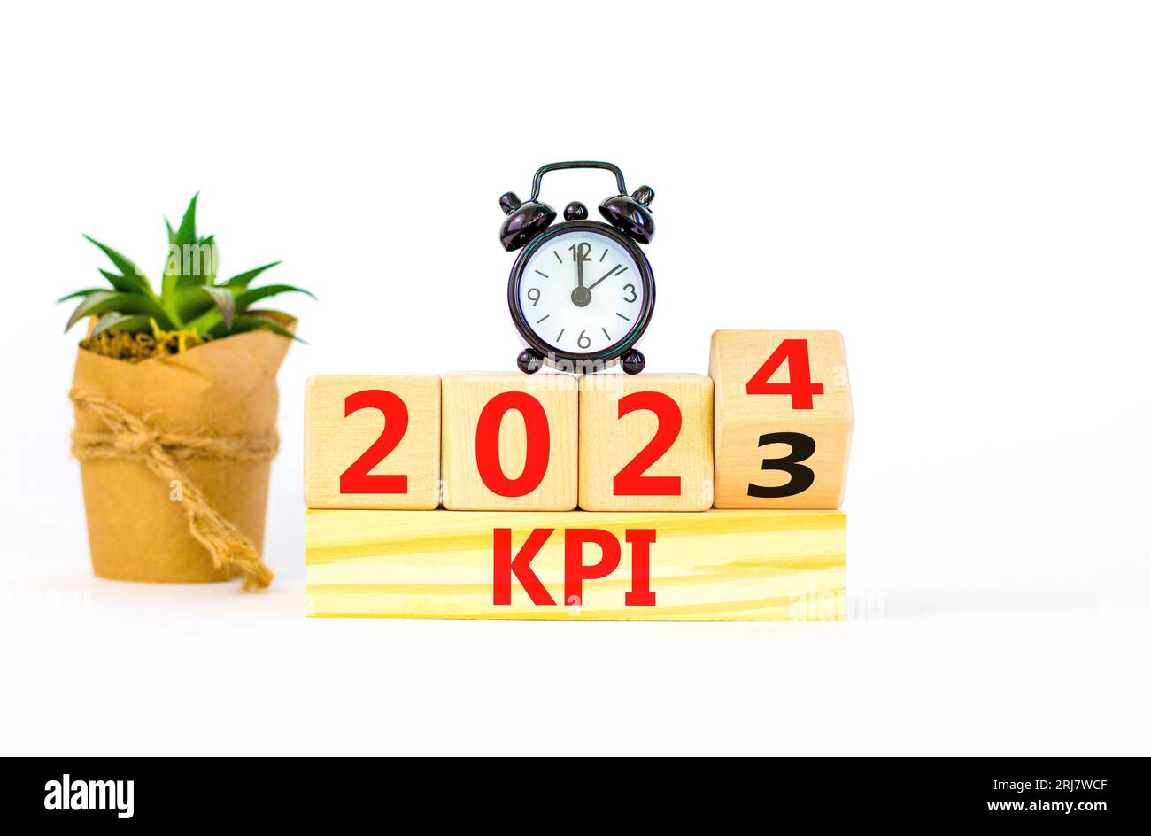 KPI, key performance indicator symbol. Businessman turns wooden cubes