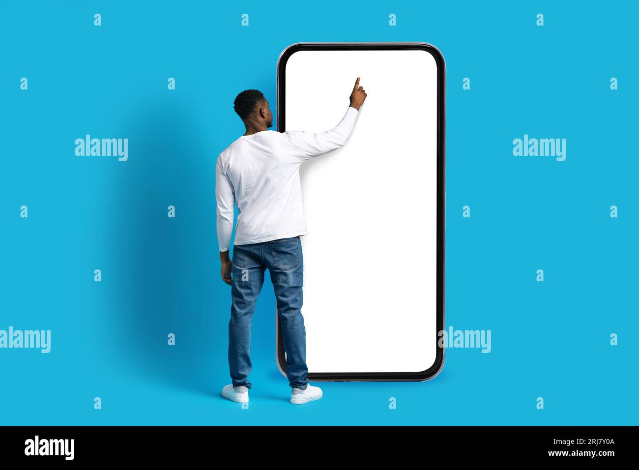 Unrecognizable african american guy touching huge phone screen Stock Photo