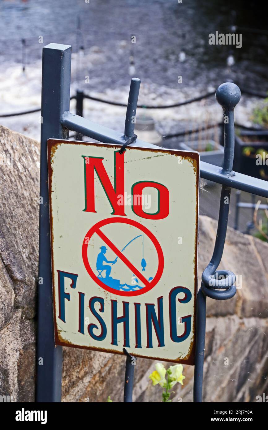 No fishing sign on railings by river Stock Photo