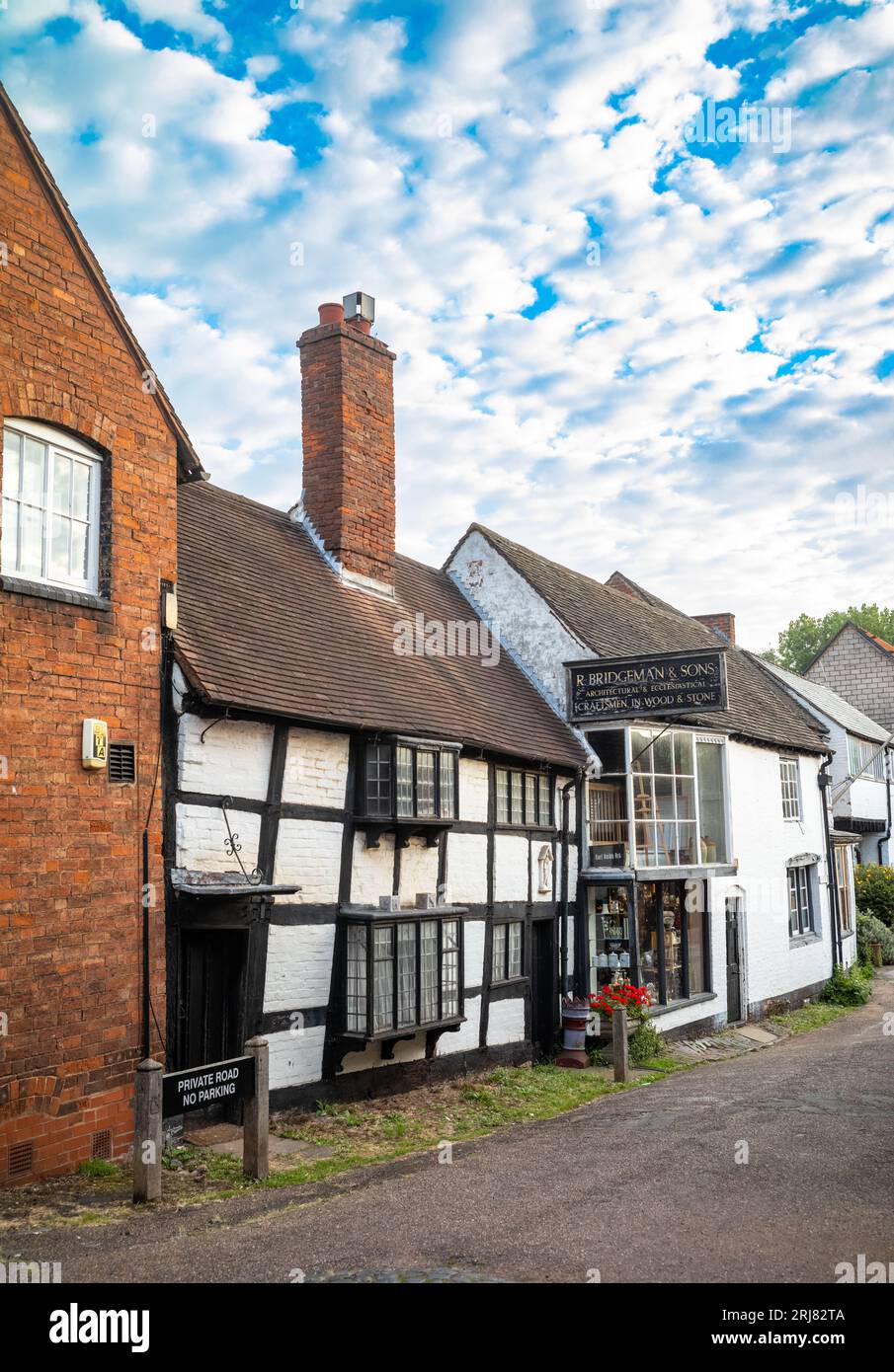 An ancient timber framed building with a tall brick chimney in the centre of Lichfield a beautiful ancient and historic city in Satffordshire, UK. Stock Photo