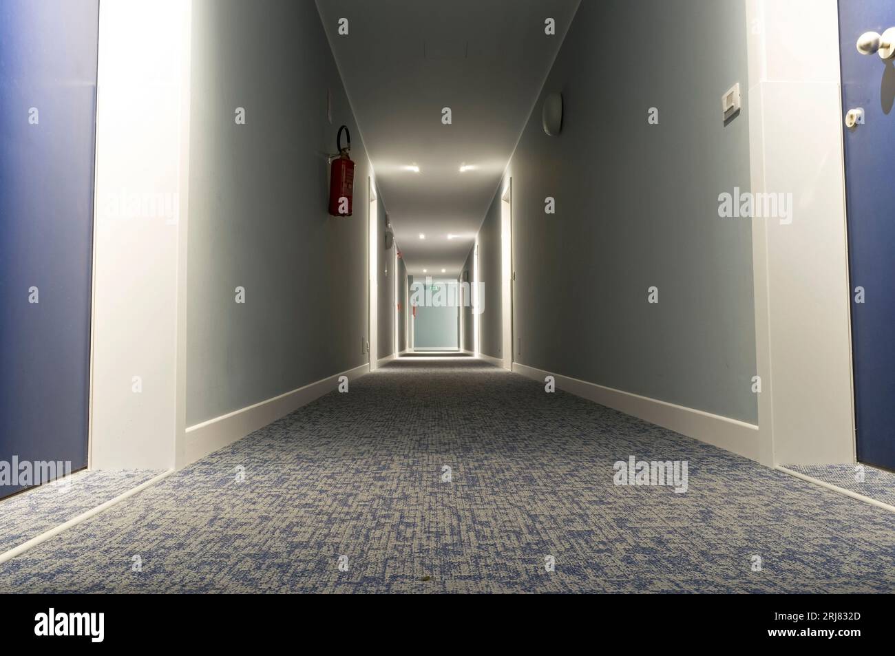 Completely deserted and eerie hotel corridor. Stock Photo