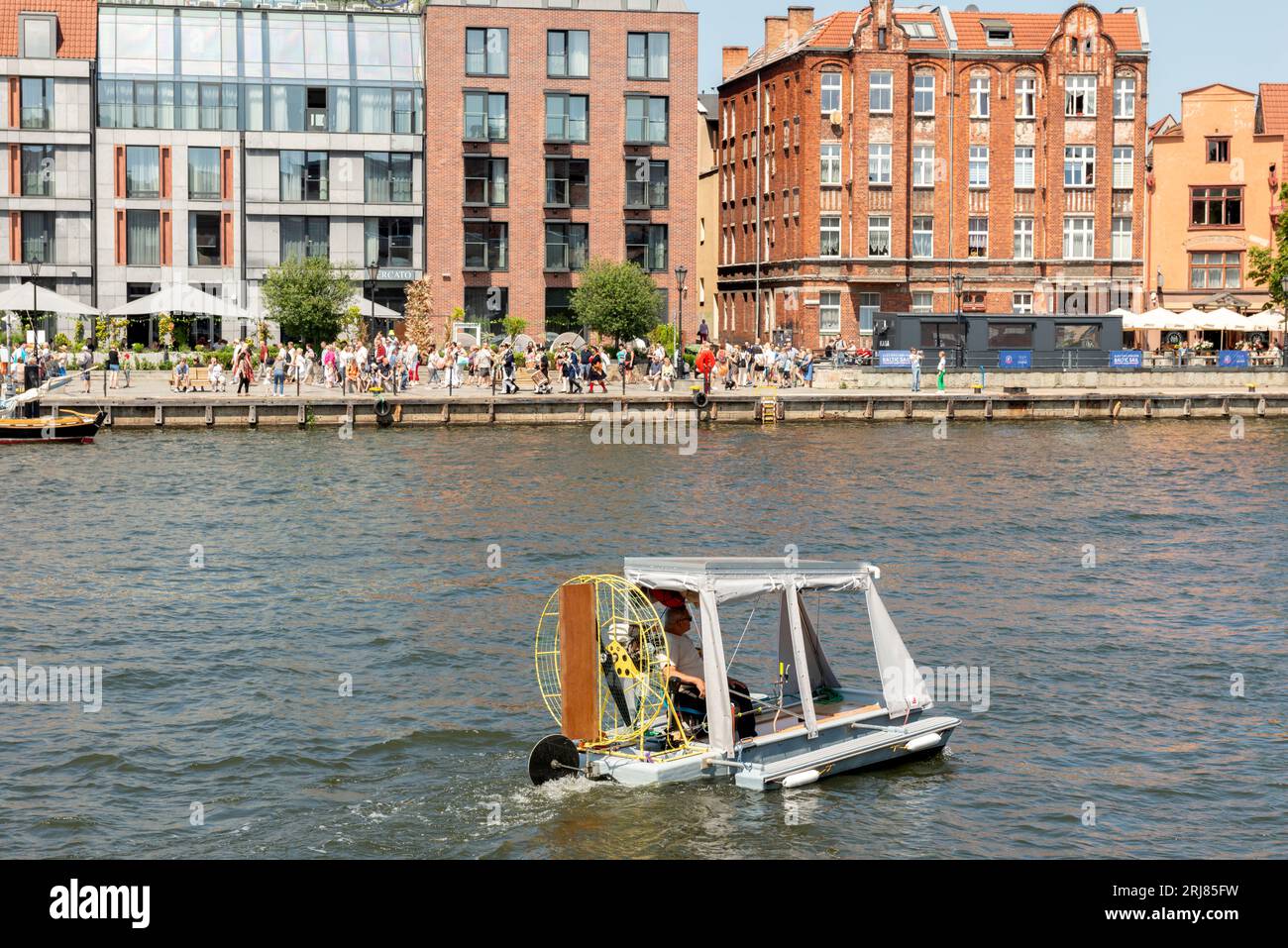 Funny DIY small vessel on Motlawa River in the Old Town of Gdansk, Poland, Europe, EU Stock Photo