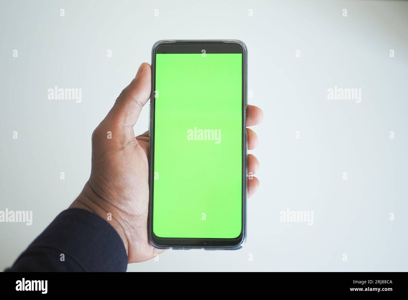 pov shot of young man hand using smart phone with green screen Stock ...