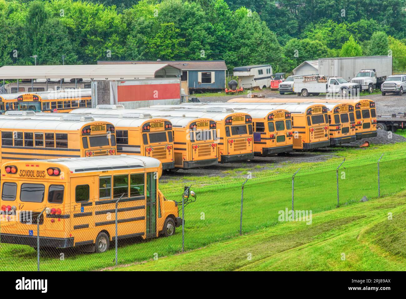 Horizontal shot of school buses in a school bus storage area Stock