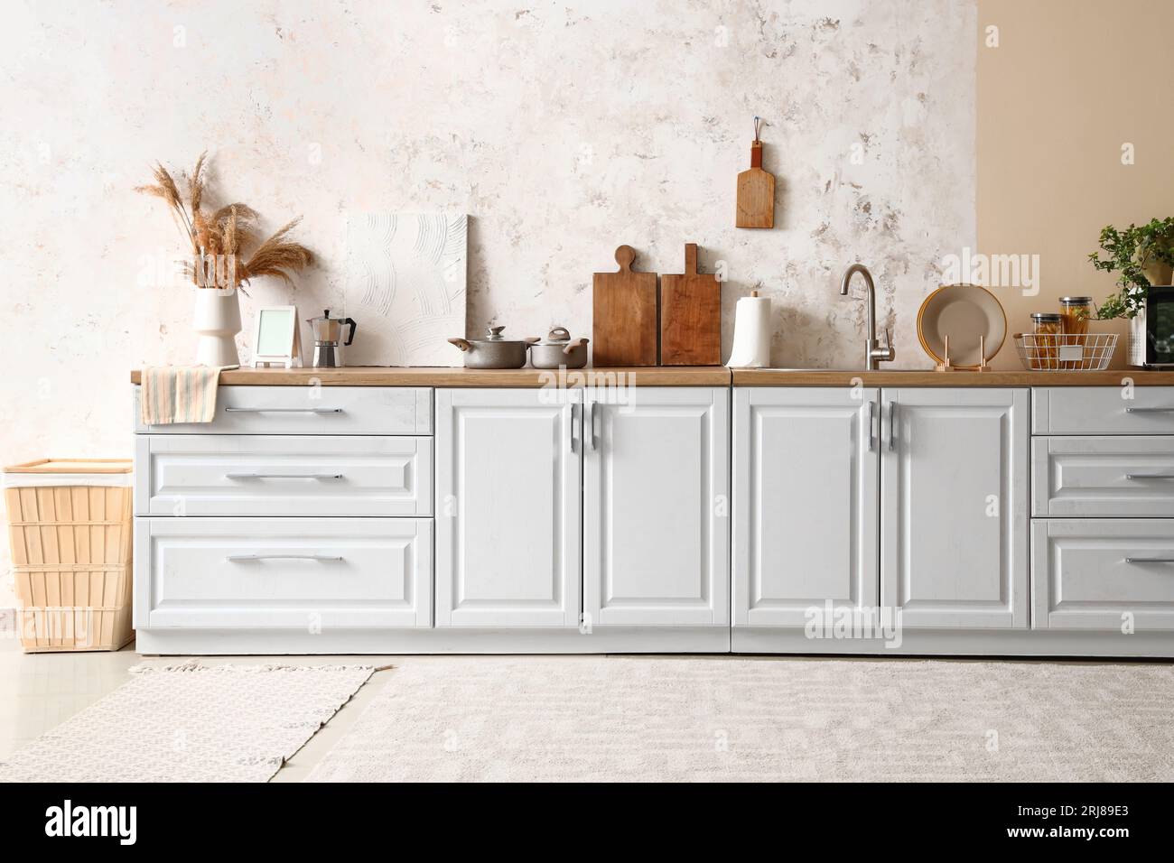 White counters with utensils and sink in modern kitchen Stock Photo - Alamy